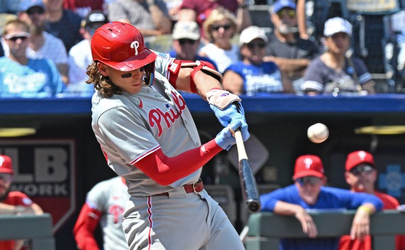 Aug 25, 2024; Kansas City, Missouri, USA;  Philadelphia Phillies third baseman Alec Bohm (28) hits an RBI single in the third inning against the Kansas City Royals at Kauffman Stadium. Mandatory Credit: Peter Aiken-USA TODAY Sports