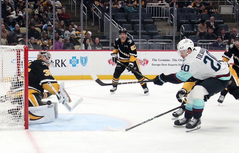 Jan 14, 2025; Pittsburgh, Pennsylvania, USA;  Seattle Kraken right wing Eeli Tolvanen (20) scores the game winning goal against Pittsburgh Penguins goaltender Tristan Jarry (35) during the third period at PPG Paints Arena. Mandatory Credit: Charles LeClaire-Imagn Images