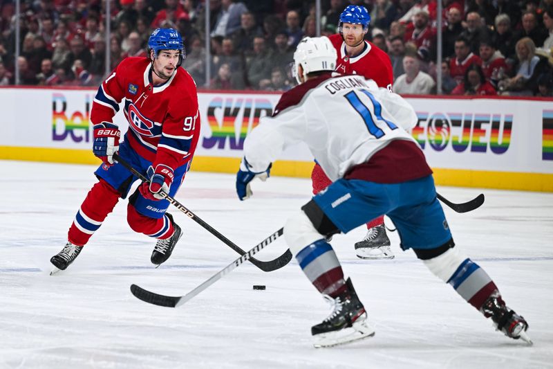 Jan 15, 2024; Montreal, Quebec, CAN; Montreal Canadiens center Sean Monahan (91) plays the puck against the Colorado Avalanche during the first period at Bell Centre. Mandatory Credit: David Kirouac-USA TODAY Sports