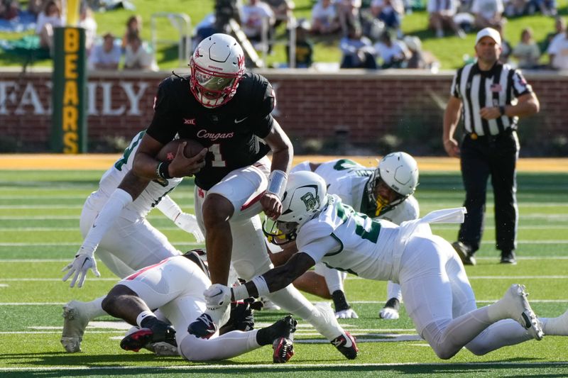 Nov 4, 2023; Waco, Texas, USA;  Houston Cougars quarterback Donovan Smith (1) runs the ball and is tackled by Baylor Bears safety Devyn Bobby (28) during the second half at McLane Stadium. Mandatory Credit: Chris Jones-USA TODAY Sports