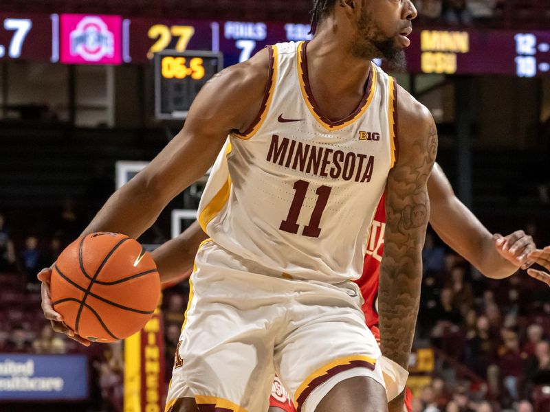 Jan 6, 2025; Minneapolis, Minnesota, USA;  Minnesota Golden Gophers guard Femi Odukale (11) controls the ball against the Ohio State Buckeyes during the first half at Williams Arena. Mandatory Credit: Nick Wosika-Imagn Images