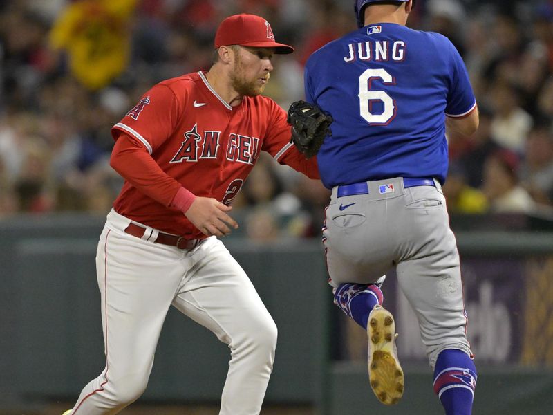 Sep 27, 2023; Anaheim, California, USA;  Texas Rangers third baseman Josh Jung (6) is tagged out at first by Los Angeles Angels second baseman Brandon Drury (23) in the third inning at Angel Stadium. Mandatory Credit: Jayne Kamin-Oncea-USA TODAY Sports