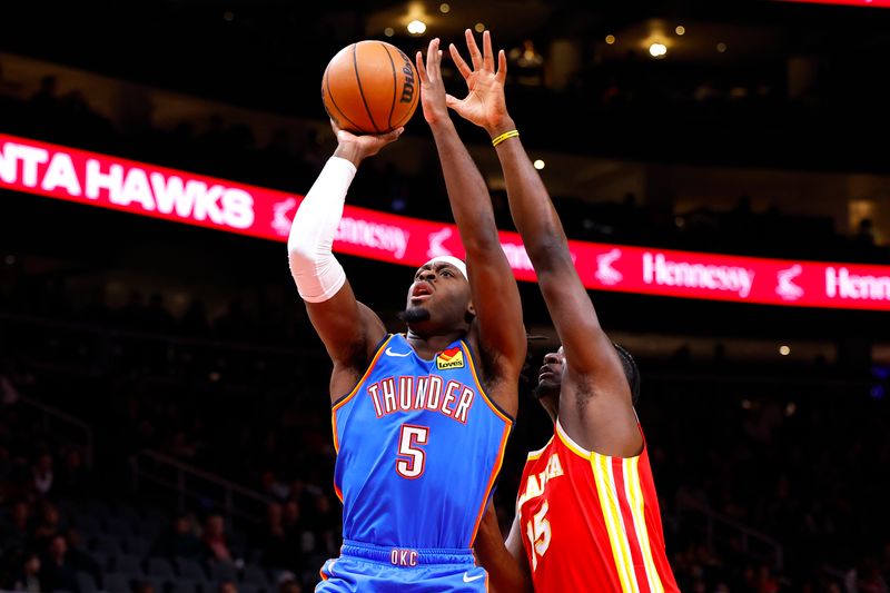 ATLANTA, GEORGIA - JANUARY 3: Luguentz Dort #5 of the Oklahoma City Thunder shoots against Clint Capela #15 of the Atlanta Hawks during the first quarter at State Farm Arena on January 3, 2024 in Atlanta, Georgia. NOTE TO USER: User expressly acknowledges and agrees that, by downloading and or using this photograph, User is consenting to the terms and conditions of the Getty Images License Agreement. (Photo by Todd Kirkland/Getty Images)