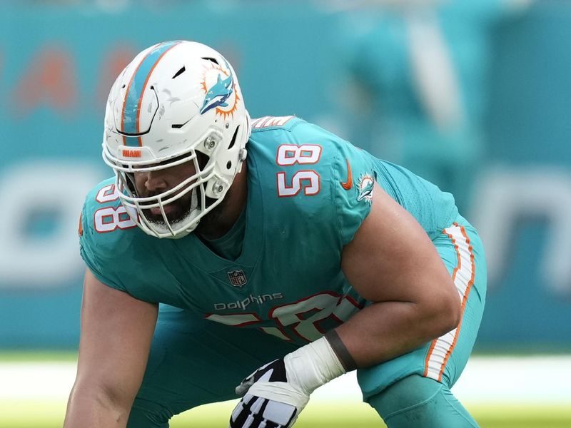 Miami Dolphins guard Connor Williams (58) prepares to hike the ball, during the first half of an NFL football game against the New York Jets, Sunday, Jan. 8, 2023, in Miami Gardens, Fla. (AP Photo/Rebecca Blackwell)