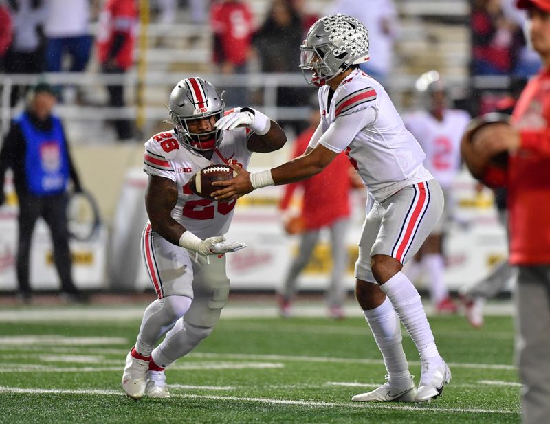 Oct 23, 2021; Bloomington, Indiana, USA;  Ohio State Buckeyes quarterback C.J. Stroud (7) hands the ball off to running back Miyan Williams (28) before a game against the Indiana Hoosiers at Memorial Stadium. Mandatory Credit: Marc Lebryk-USA TODAY Sports