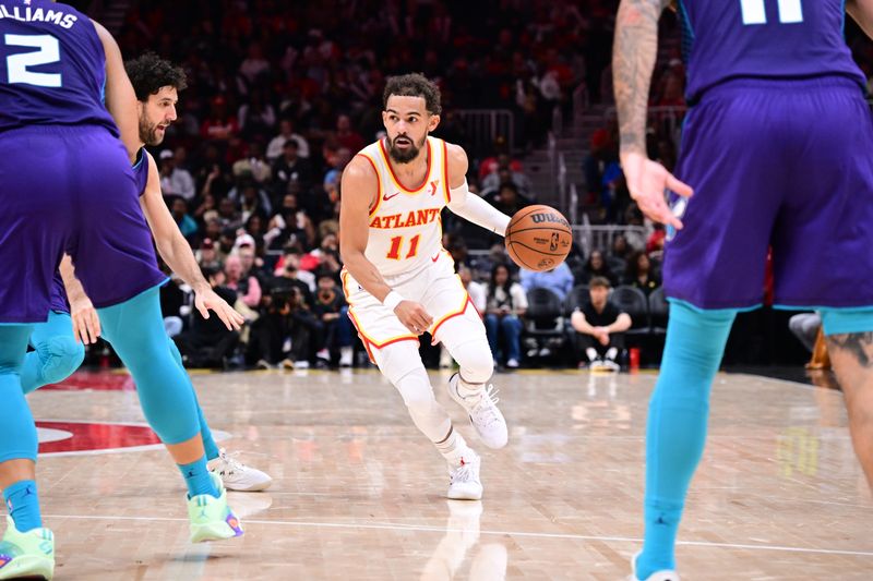 ATLANTA, GA - OCTOBER 25: Trae Young #11 of the Atlanta Hawks dribbles the ball during the game against the Charlotte Hornets on October 25, 2024 at State Farm Arena in Atlanta, Georgia.  NOTE TO USER: User expressly acknowledges and agrees that, by downloading and/or using this Photograph, user is consenting to the terms and conditions of the Getty Images License Agreement. Mandatory Copyright Notice: Copyright 2024 NBAE (Photo by Adam Hagy/NBAE via Getty Images)