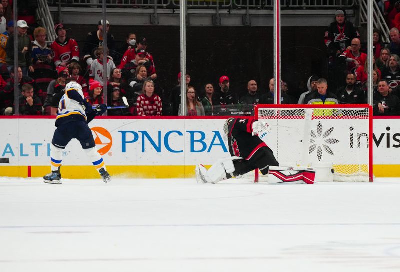 Jan 6, 2024; Raleigh, North Carolina, USA; St. Louis Blues center Brayden Schenn (10) scores the game winner in the shoot out against Carolina Hurricanes goaltender Antti Raanta (32) at PNC Arena. Mandatory Credit: James Guillory-USA TODAY Sports