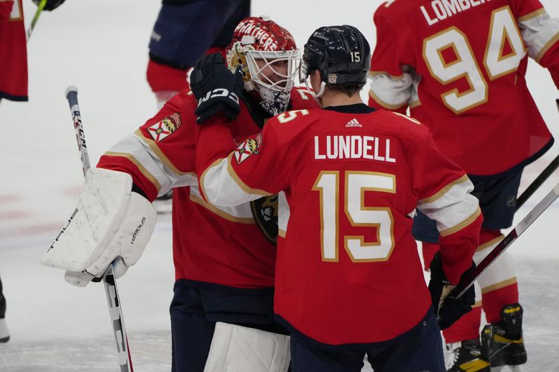 Feb 20, 2024; Sunrise, Florida, USA; Florida Panthers goaltender Sergei Bobrovsky (72) congratulates center Anton Lundell (15) on scoring the winning overtime goal against the Ottawa Senators at Amerant Bank Arena. Mandatory Credit: Jim Rassol-USA TODAY Sports