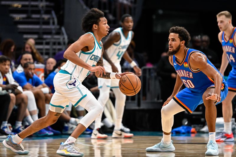 CHARLOTTE, NORTH CAROLINA - OCTOBER 15: Nick Smith Jr. looks to drive past Jeremiah Robinson-Earl #50 of the Oklahoma City Thunder during the second half of their game at Spectrum Center on October 15, 2023 in Charlotte, North Carolina. NOTE TO USER: User expressly acknowledges and agrees that, by downloading and or using this photograph, User is consenting to the terms and conditions of the Getty Images License Agreement.? (Photo by Matt Kelley/Getty Images)