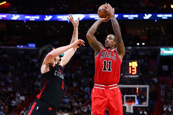 MIAMI, FLORIDA - DECEMBER 16: DeMar DeRozan #11 of the Chicago Bulls shoots the ball over Jaime Jaquez Jr. #11 of the Miami Heat during the third quarter of the game at Kaseya Center on December 16, 2023 in Miami, Florida. NOTE TO USER: User expressly acknowledges and agrees that, by downloading and or using this photograph, User is consenting to the terms and conditions of the Getty Images License Agreement. (Photo by Megan Briggs/Getty Images)