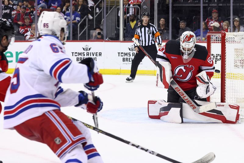 Sep 30, 2024; Newark, New Jersey, USA; New Jersey Devils goaltender Jeremy Brodeur (60) makes a save against the New York Rangers during the third period at Prudential Center. Mandatory Credit: Ed Mulholland-Imagn Images