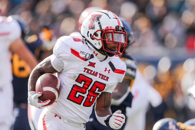 Nov 9, 2019; Morgantown, WV, USA; Texas Tech Red Raiders running back Ta'Zhawn Henry (26) runs the ball during the third quarter against the West Virginia Mountaineers at Mountaineer Field at Milan Puskar Stadium. Mandatory Credit: Ben Queen-USA TODAY Sports