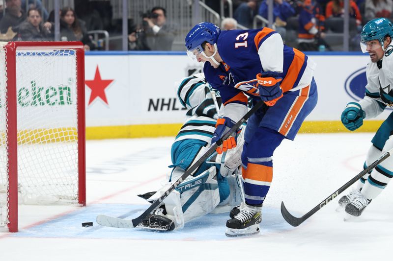 Jan 18, 2025; Elmont, New York, USA;  New York Islanders center Mathew Barzal (13) scores a goal against the San Jose Sharks during the second period at UBS Arena. Mandatory Credit: Thomas Salus-Imagn Images