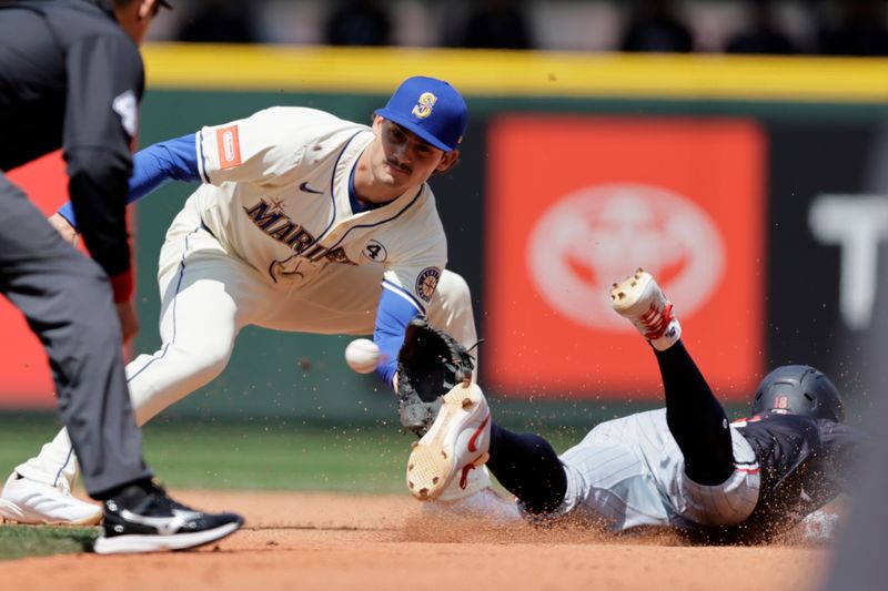 Jun 1, 2025; Seattle, Washington, USA; Seattle Mariners second baseman Cole Young (2) reaches for the throw before tagging Minnesota Twins first baseman Ty France (13) out at second on a steal attempt during the fourth inning at T-Mobile Park. Mandatory Credit: John Froschauer-Imagn Images