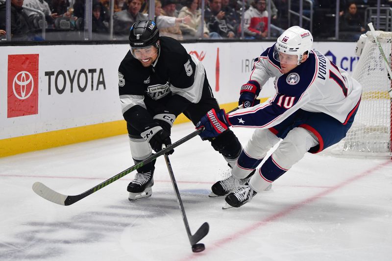 Dec 22, 2025; Los Angeles, California, USA; Columbus Blue Jackets left wing Dmitri Voronkov (10) plays for the puck against Los Angeles Kings defenseman Cody Ceci (5) during the third period at Crypto.com Arena. Mandatory Credit: Gary A. Vasquez-Imagn Images