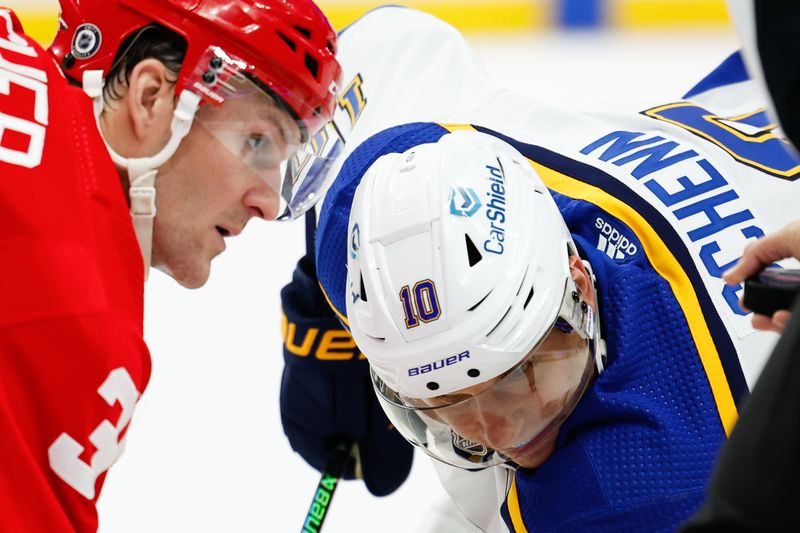 Feb 24, 2024; Detroit, Michigan, USA;  Detroit Red Wings right wing Christian Fischer (36) and St. Louis Blues center Brayden Schenn (10) face off in the third period at Little Caesars Arena. Mandatory Credit: Rick Osentoski-USA TODAY Sports