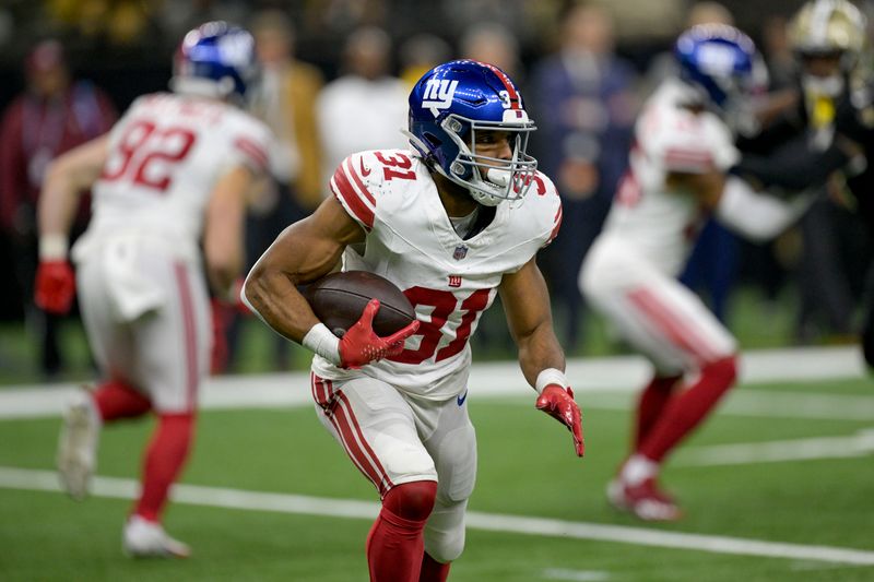 New York Giants running back Matt Breida (31) runs during an NFL football game against the New Orleans Saints in New Orleans, Sunday, Dec. 17, 2023. (AP Photo/Matthew Hinton)