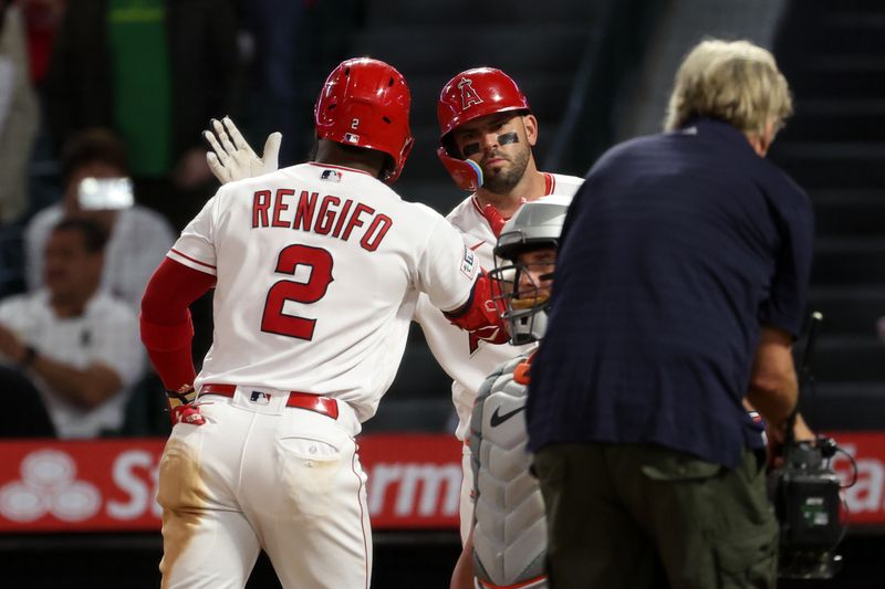 Sep 6, 2023; Anaheim, California, USA;  Los Angeles Angels shortstop Luis Rengifo (2) is greeted by third baseman Mike Moustakas (8) after hitting a 2-run home run during the third inning against the Baltimore Orioles at Angel Stadium. Mandatory Credit: Kiyoshi Mio-USA TODAY Sports