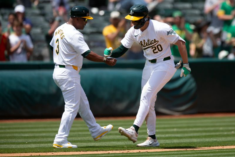 Jun 20, 2024; Oakland, California, USA; Oakland Athletics second baseman Zack Gelof (20) is congratulated by third base coach Eric Martins (3) after hitting a two-run home run against the Kansas City Royals during the seventh inning at Oakland-Alameda County Coliseum. Mandatory Credit: D. Ross Cameron-USA TODAY Sports