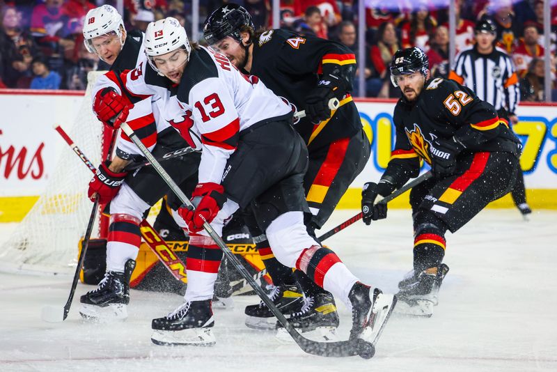 Dec 9, 2023; Calgary, Alberta, CAN; New Jersey Devils center Nico Hischier (13) controls the puck against the Calgary Flames during the third period at Scotiabank Saddledome. Mandatory Credit: Sergei Belski-USA TODAY Sports