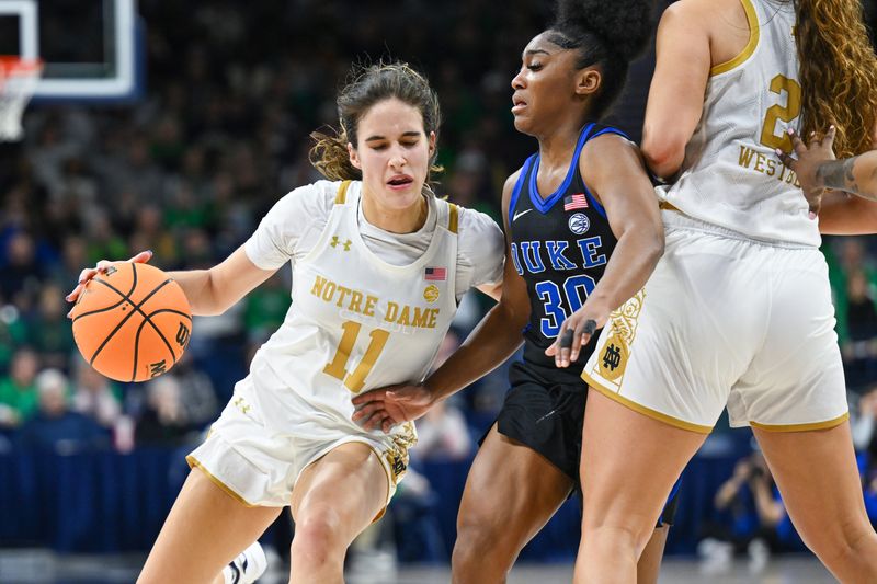 Feb 5, 2023; South Bend, Indiana, USA; Notre Dame Fighting Irish guard Sonia Citron (11) dribbles as Duke Blue Devils gaurd Shayeann Day-Wilson (30) defends in the second half at the Purcell Pavilion. Mandatory Credit: Matt Cashore-USA TODAY Sports