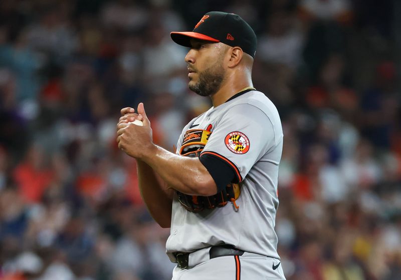 Jun 23, 2024; Houston, Texas, USA; Baltimore Orioles starting pitcher Albert Suarez (49) works the ball before pitching against the Houston Astros in the first inning at Minute Maid Park. Mandatory Credit: Thomas Shea-USA TODAY Sports