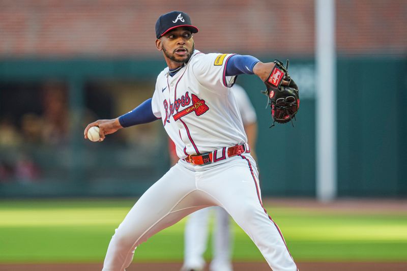 Apr 21, 2024; Cumberland, Georgia, USA; Atlanta Braves starting pitcher Darius Vines (61) pitches against the Texas Rangers during the first inning at Truist Park. Mandatory Credit: Dale Zanine-USA TODAY Sports