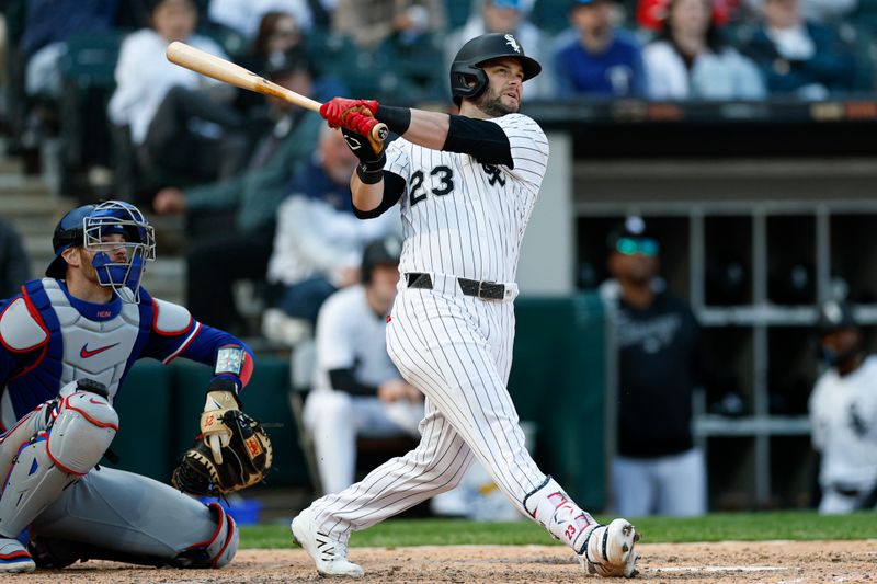 May 24, 2025; Chicago, Illinois, USA; Chicago White Sox designated hitter Andrew Benintendi (23) hits a two-run double against the Texas Rangers during the sixth inning at Rate Field. Mandatory Credit: Kamil Krzaczynski-Imagn Images