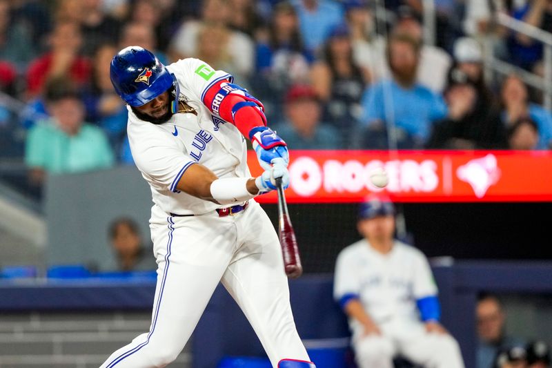 Jun 29, 2024; Toronto, Ontario, CAN; Toronto Blue Jays first base Vladimir Guerrero Jr. (27) hits a home run against the New York Yankees during the first inning at Rogers Centre. Mandatory Credit: Kevin Sousa-USA TODAY Sports