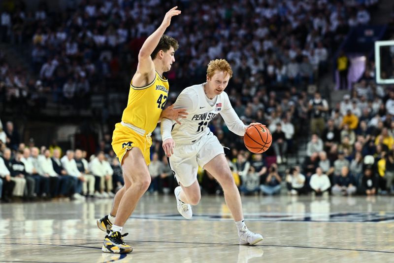 Jan 7, 2024; Philadelphia, Pennsylvania, USA; Penn State Nittany Lions forward Leo O'Boyle (11) drives against Michigan Wolverines forward Will Tschetter (42) in the first half at The Palestra. Mandatory Credit: Kyle Ross-USA TODAY Sports