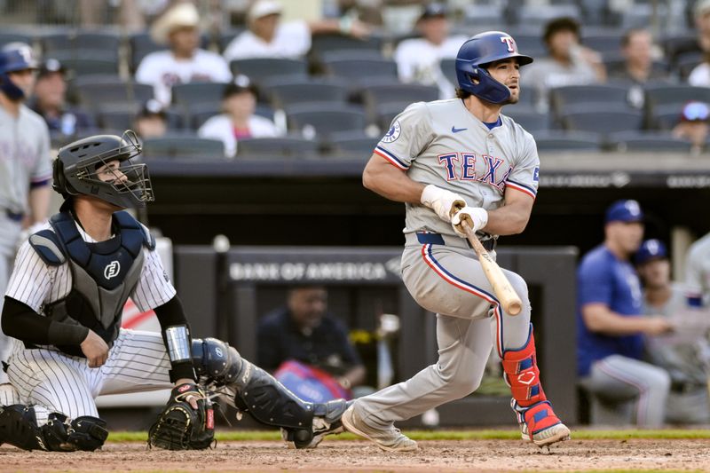 Aug 10, 2024; Bronx, New York, USA; Texas Rangers third baseman Josh Smith (8) hits a single against the New York Yankees during the seventh inning at Yankee Stadium. Mandatory Credit: John Jones-USA TODAY Sports