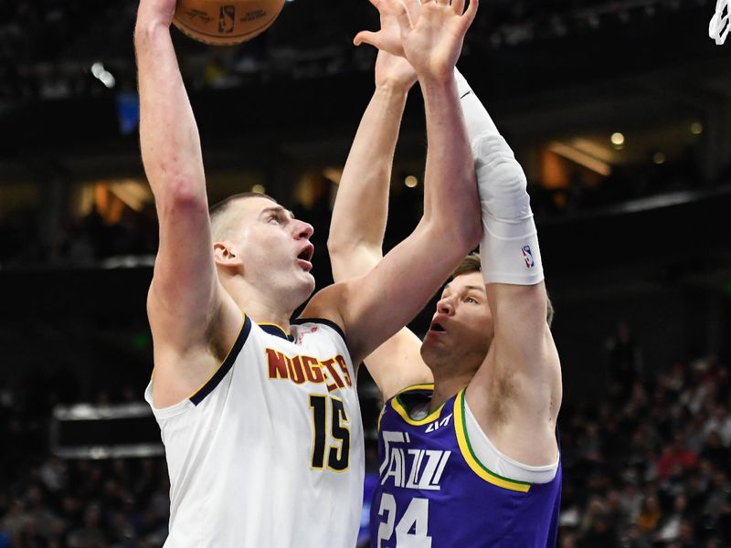SALT LAKE CITY, UTAH - JANUARY 10: Nikola Jokic #15 of the Denver Nuggets shoots against Walker Kessler #24 of the Utah Jazz during the second half of a game at Delta Center on January 10, 2024 in Salt Lake City, Utah.  NOTE TO USER: User expressly acknowledges and agrees that, by downloading and or using this photograph, User is consenting to the terms and conditions of the Getty Images License Agreement. (Photo by Alex Goodlett/Getty Images)