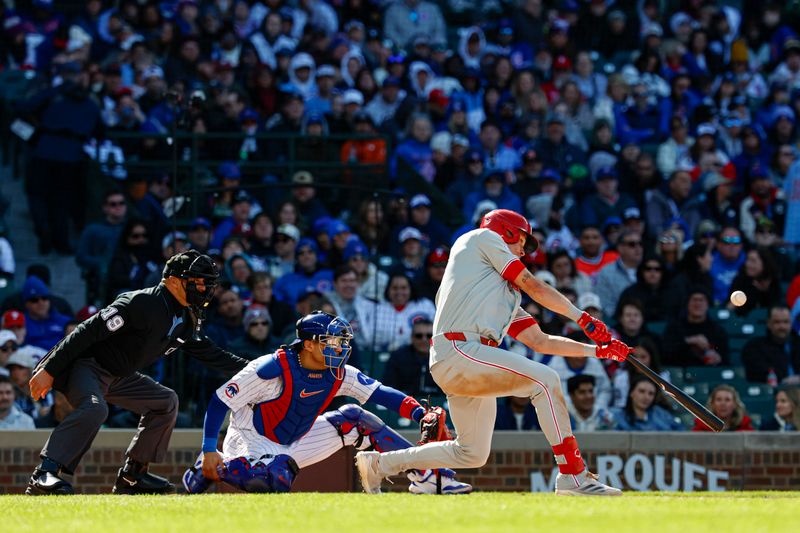 Apr 26, 2025; Chicago, Illinois, USA; Philadelphia Phillies left fielder Max Kepler (17) hits an RBI-single against the Chicago Cubs during the fourth inning at Wrigley Field. Mandatory Credit: Kamil Krzaczynski-Imagn Images