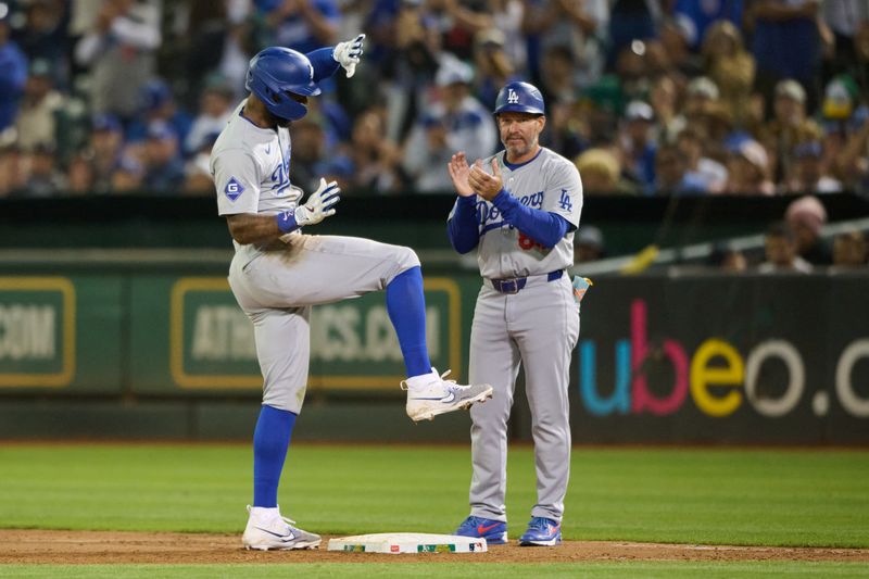 Aug 3, 2024; Oakland, California, USA; Los Angeles Dodgers outfielder Jason Heyward (23) celebrates with third base coach Dino Ebel (91) after hitting an RBI single against the Oakland Athletics during the ninth inning at Oakland-Alameda County Coliseum. Mandatory Credit: Robert Edwards-USA TODAY Sports