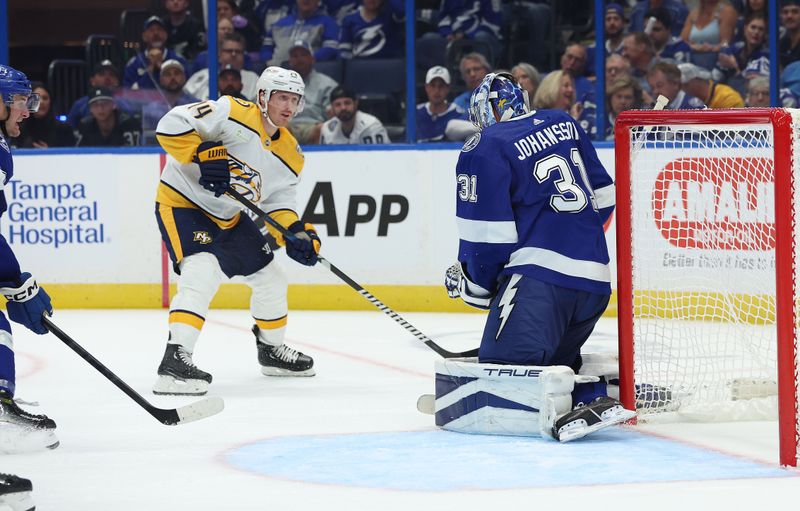 Oct 10, 2023; Tampa, Florida, USA; Nashville Predators left wing Gustav Nyquist (14) shoots on Tampa Bay Lightning goaltender Jonas Johansson (31) during the second period at Amalie Arena. Mandatory Credit: Kim Klement Neitzel-USA TODAY Sports