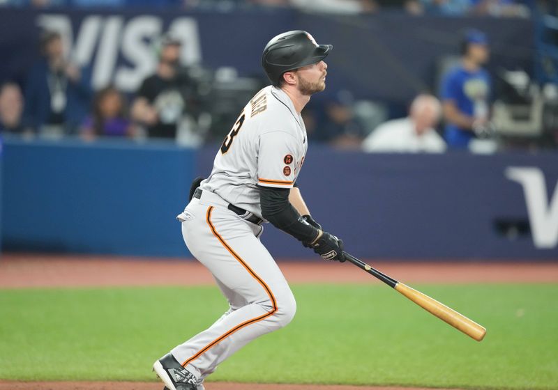 Jun 28, 2023; Toronto, Ontario, CAN; San Francisco Giants right fielder Austin Slater (13) hits a home run against the Toronto Blue Jays during the fifth inning at Rogers Centre. Mandatory Credit: Nick Turchiaro-USA TODAY Sports