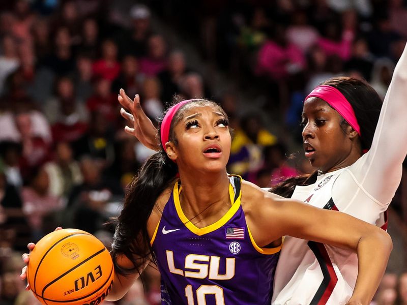 Feb 12, 2023; Columbia, South Carolina, USA; LSU Lady Tigers forward Angel Reese (10) drives around South Carolina Gamecocks forward Laeticia Amihere (15) in the second half at Colonial Life Arena. Mandatory Credit: Jeff Blake-USA TODAY Sports