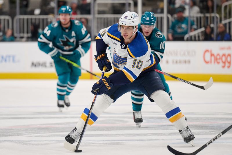 Apr 6, 2024; San Jose, California, USA; St. Louis Blues center Brayden Schenn (10) plays the puck against the San Jose Sharks during the first period at SAP Center at San Jose. Mandatory Credit: Robert Edwards-USA TODAY Sports