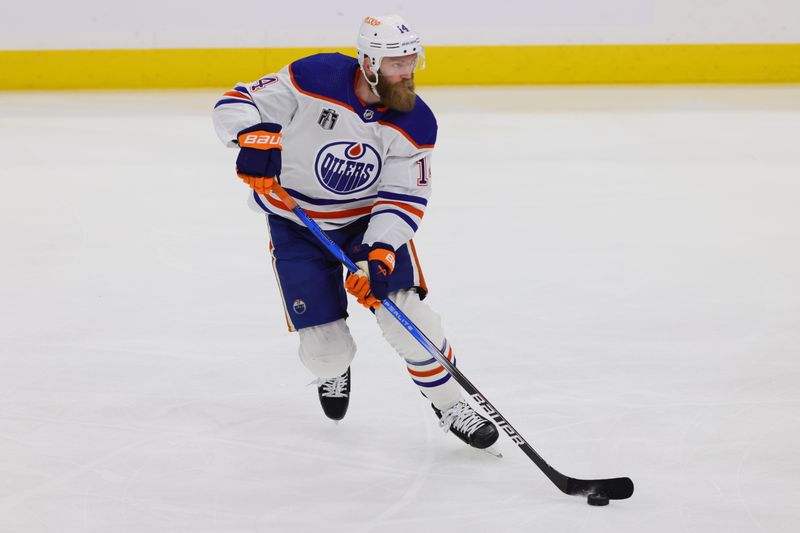 Jun 10, 2024; Sunrise, Florida, USA; Edmonton Oilers defenseman Mattias Ekholm (14) controls the puck during the first period against the Florida Panthers in game two of the 2024 Stanley Cup Final at Amerant Bank Arena. Mandatory Credit: Sam Navarro-USA TODAY Sports