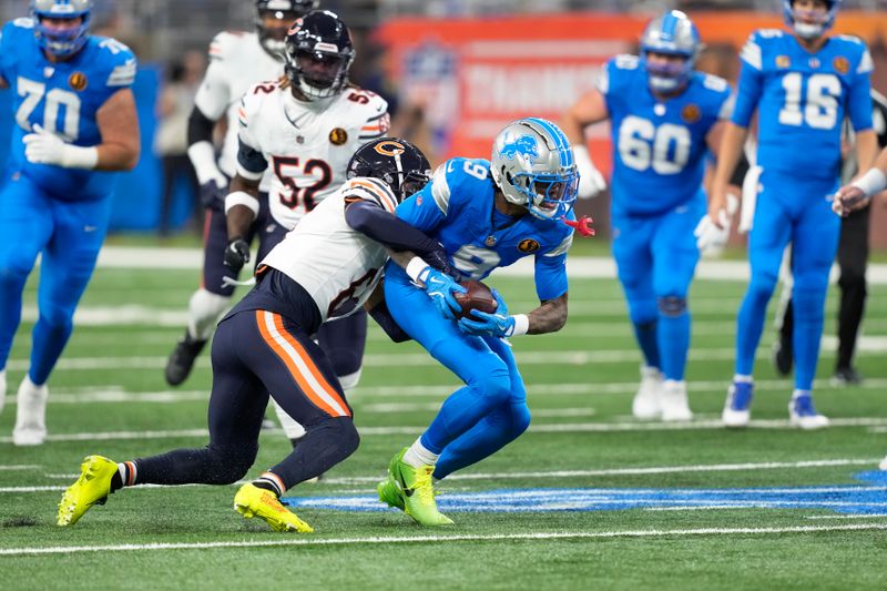 Detroit Lions wide receiver Jameson Williams (9) is brought down by Chicago Bears cornerback Kyler Gordon (6) during the first half of an NFL football game, Sunday, Nov. 17, 2024, in Detroit. (AP Photo/Carlos Osorio)