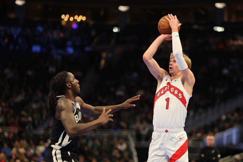 MILWAUKEE, WISCONSIN - NOVEMBER 12: Gradey Dick #1 of the Toronto Raptors shoots over Taurean Prince #12 of the Milwaukee Bucks during the first half of a game in the NBA Emirates Cup at Fiserv Forum on November 12, 2024 in Milwaukee, Wisconsin. NOTE TO USER: User expressly acknowledges and agrees that, by downloading and or using this photograph, User is consenting to the terms and conditions of the Getty Images License Agreement. (Photo by Stacy Revere/Getty Images)