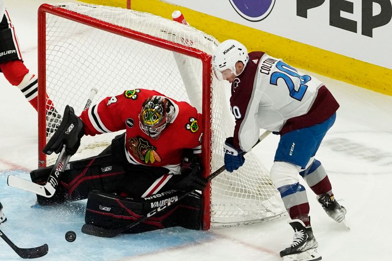 Feb 29, 2024; Chicago, Illinois, USA; Chicago Blackhawks goaltender Petr Mrazek (34) makes a save on Colorado Avalanche center Ross Colton (20) during the third period at United Center. Mandatory Credit: David Banks-USA TODAY Sports