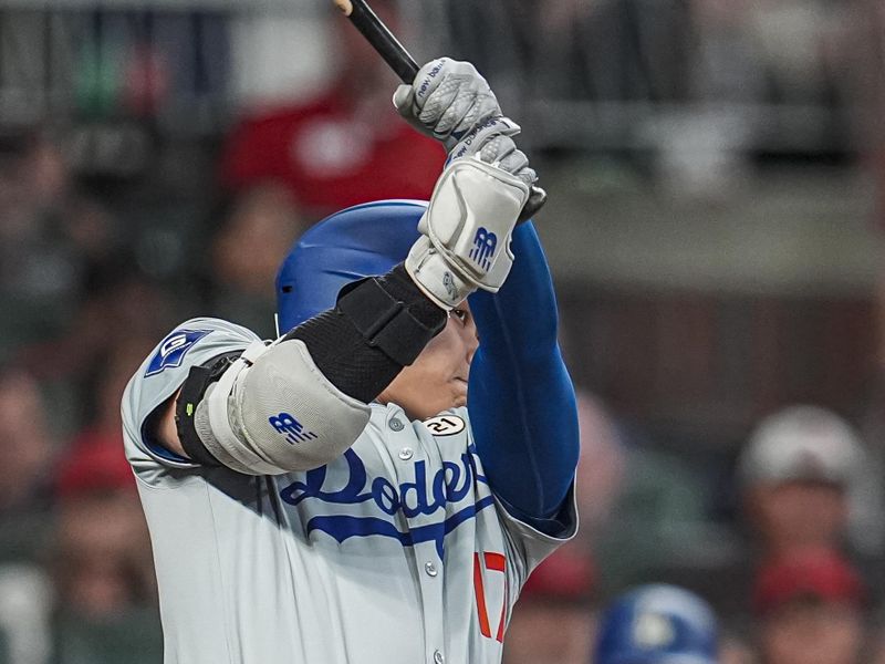 Sep 15, 2024; Cumberland, Georgia, USA; Los Angeles Dodgers designated hitter Shohei Ohtani (17) doubles to drive in a run against the Atlanta Braves during the fifth inning at Truist Park. Mandatory Credit: Dale Zanine-Imagn Images