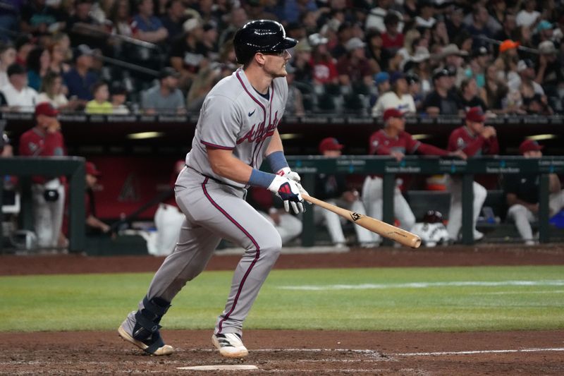 Apr 25, 2025; Phoenix, Arizona, USA; Atlanta Braves catcher Sean Murphy (12) hits a double against the Atlanta Braves in the eighth inning at Chase Field. Mandatory Credit: Rick Scuteri-Imagn Images