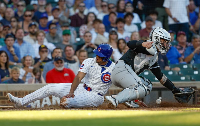 Jun 5, 2024; Chicago, Illinois, USA; Chicago Cubs third baseman Christopher Morel (5) scores against Chicago White Sox catcher Martín Maldonado (15) during the second inning at Wrigley Field. Mandatory Credit: Kamil Krzaczynski-USA TODAY Sports