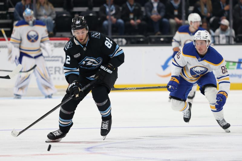 Nov 12, 2025; Salt Lake City, Utah, USA; Utah Mammoth center Kevin Stenlund (82) and Buffalo Sabres center Noah Ostlund (86) play for the puck during the second period at Delta Center. Mandatory Credit: Rob Gray-Imagn Images