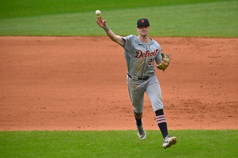 Oct 12, 2024; Cleveland, Ohio, USA; Detroit Tigers shortstop Trey Sweeney (27) throws to first base in the seventh inning against the Cleveland Guardians during game five of the ALDS for the 2024 MLB Playoffs at Progressive Field. Mandatory Credit: David Richard-Imagn Images
