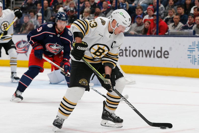 Jan 2, 2024; Columbus, Ohio, USA; Boston Bruins left wing Brad Marchand (63) grabs a loose puck against the Columbus Blue Jackets during the second period at Nationwide Arena. Mandatory Credit: Russell LaBounty-USA TODAY Sports