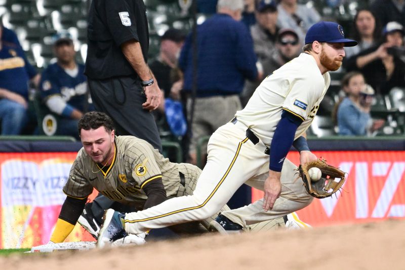 Apr 17, 2024; Milwaukee, Wisconsin, USA; San Diego Padres center fielder Jackson Merrill (3) slides into third base with a triple before tag by Milwaukee Brewers third baseman Oliver Dunn (15) in the seventh inning at American Family Field. Mandatory Credit: Benny Sieu-USA TODAY Sports