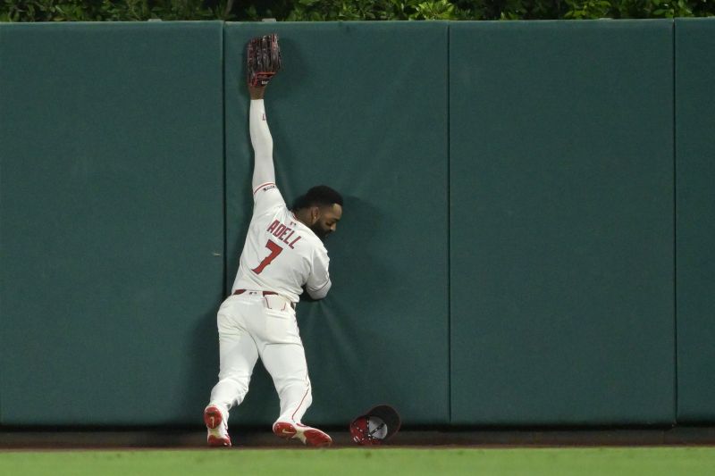 Jun 9, 2025; Anaheim, California, USA;   Los Angeles Angels center fielder Jo Adell (7) can’t make the catch at the wall on a pinch hit two run home run by Athletics center fielder JJ Bleday (33) at Angel Stadium. Mandatory Credit: Jayne Kamin-Oncea-Imagn Images